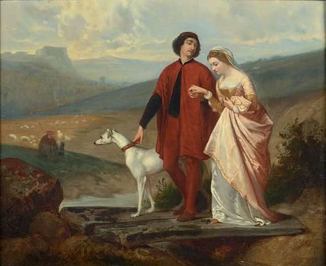 A young couple and a white dog cross a rustic plank bridge through a hilly rural landscape.